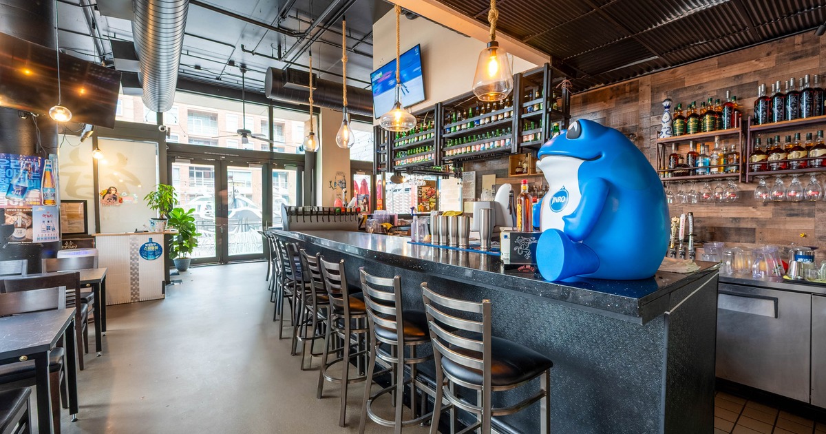 Interior, bar area, marble top bar with padded bar stools, large drink shelves in the back