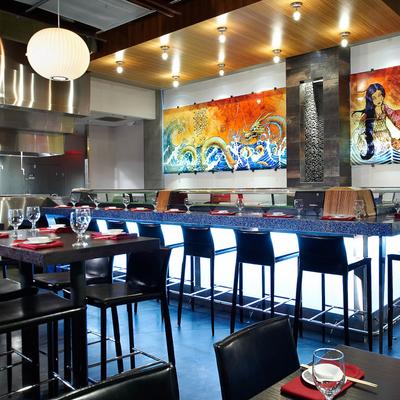 Interior, a colorful dragon mural adorns the wall, sushi bar and dining tables with tableware.