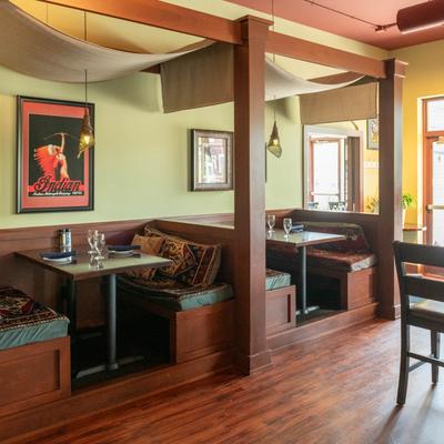 Interior with wooden booths and wall art.