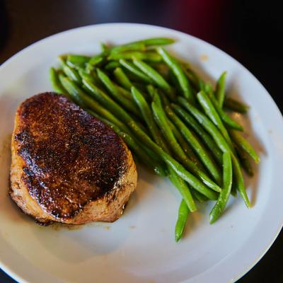 Eight ounce sirloin served with green beans.
