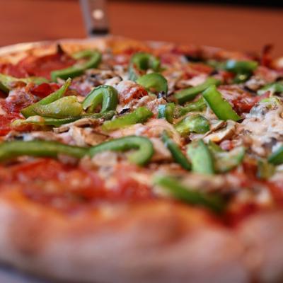 Pizza with pepperoni, Italian sausage, ham, mushrooms, and green bell peppers.