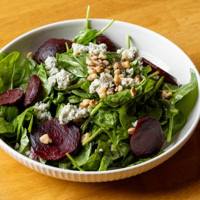 Spinach and beet salad with blue cheese and walnuts.