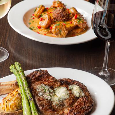 Grilled ribeye steak, baked potato, broccolini, and Black Pepper Shrimp on the side