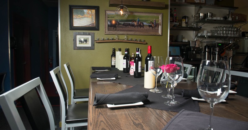 Interior, table setting with served bottles of wine