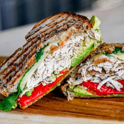 Chicken sandwich, with roasted red peppers, cheddar, avocado, jalapeno, and arugula.