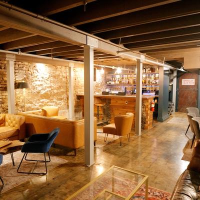 Interior with exposed brick, comfortable seating, and warm lighting.