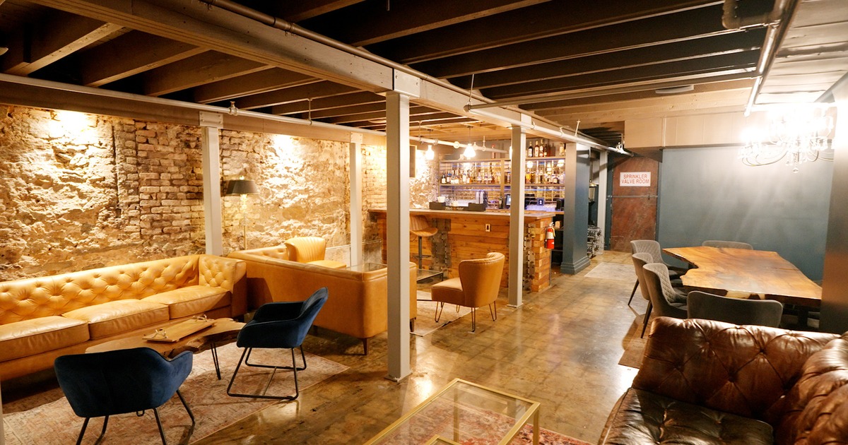 Interior with exposed brick, comfortable seating, and warm lighting