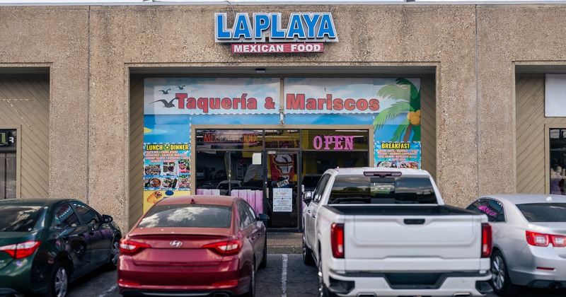 Exterior, front of restaurant, part of parking lot with vehicles