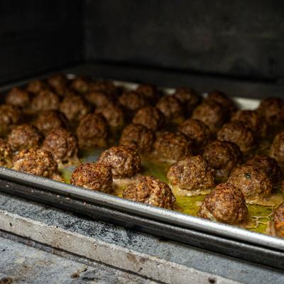 Kitchen shots, a tray filled with freshly cooked meatballs.