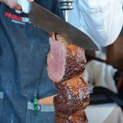 A person slicing meat.