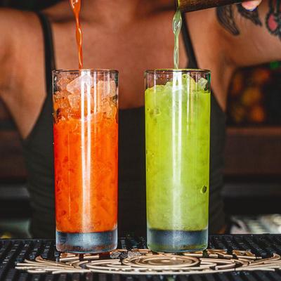 Bartender pouring two cocktails, closeup