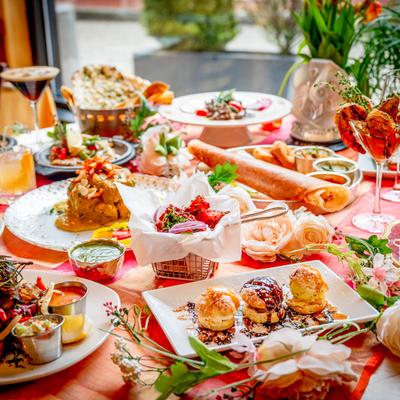 Vibrant table spread of various dishes and cocktails.