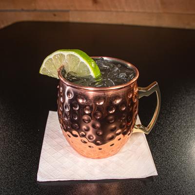 Moscow Mule served in a copper mug, garnished with a slice of lime.