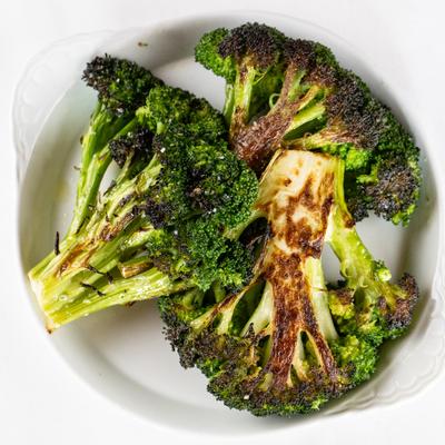 Grilled Broccoli on a white plate.