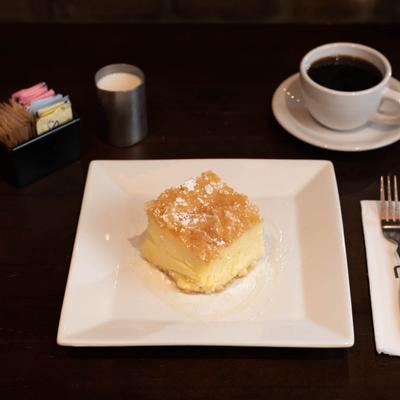 Custard pie, served with a cup of coffee.