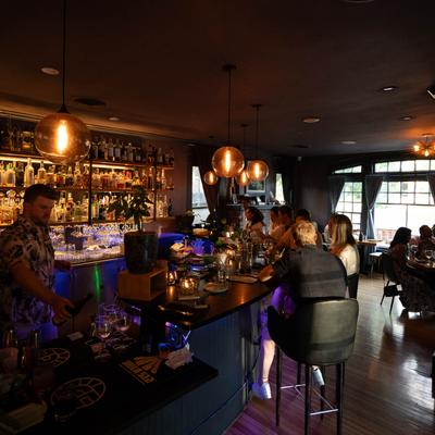 People enjoying drinks in a dimly lit bar.