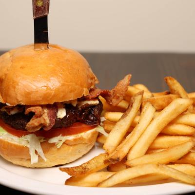 Bacon cheeseburger with fries.