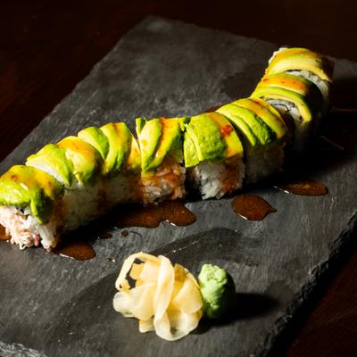 Sawadee Roll topped with avocado and sweet chili sauce.