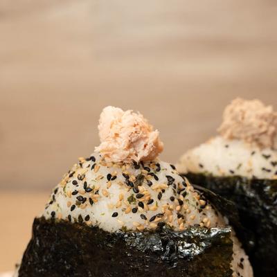 Stuffed rice balls wrapped with nori seaweed, close up.