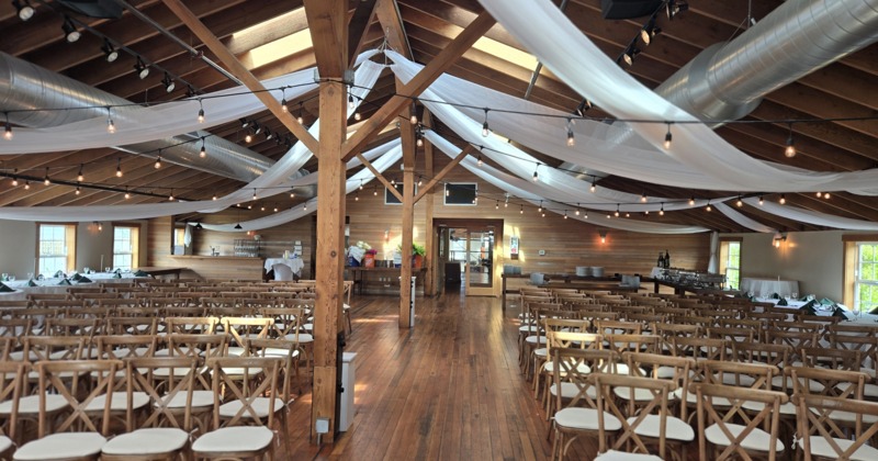 Interior, seating area by fireplace, wall decorated with paintings