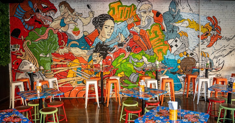 Interior, chairs and tables next to the painted wall