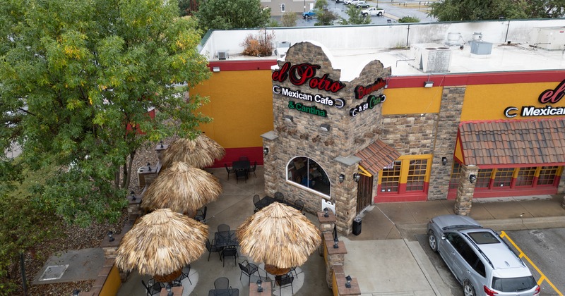 Exterior, aerial view to restaurant, garden, with tables, chairs, parasols