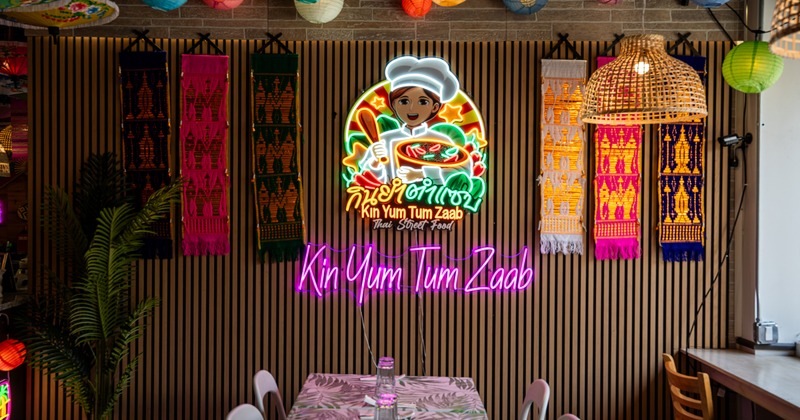 Interior, dining tables and chairs, neon signs on walls