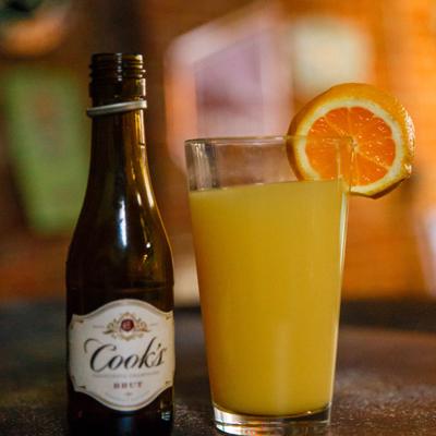 Cook's California Champagne bottle and a Mimosa cocktail