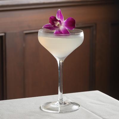 Limoncello Martini served in coupe and garnished with a orchid flower.