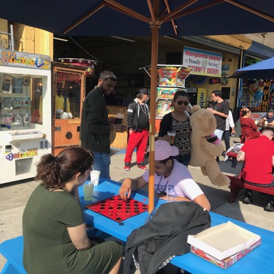 Restaurant exterior, guests enjoying food and drinks.