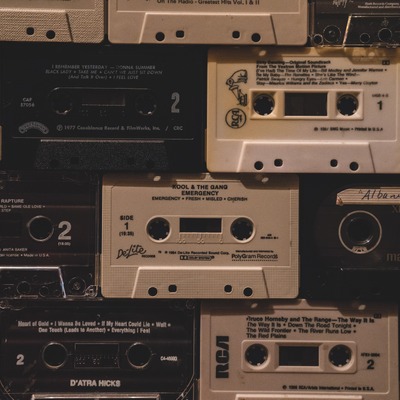 Wall covered in cassette tapes, close-up.