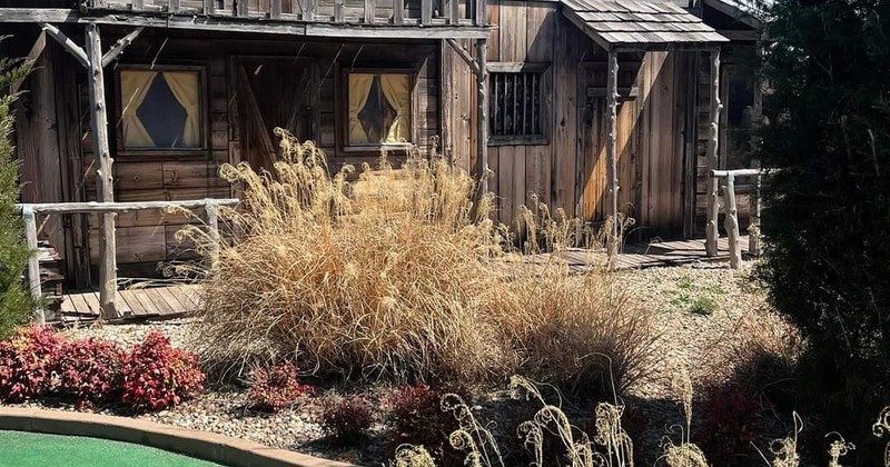Exterior, view of restaurant over part of golf terrain and lake