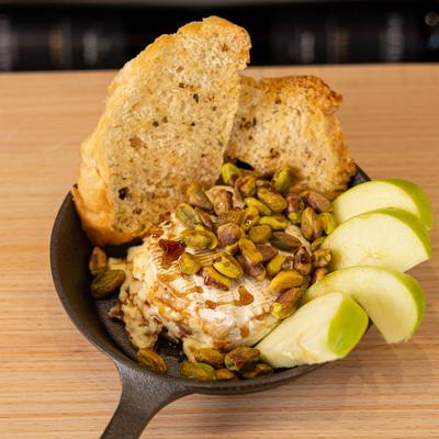Baked Brie, with apples, nuts, crostini, and balsamic glaze.