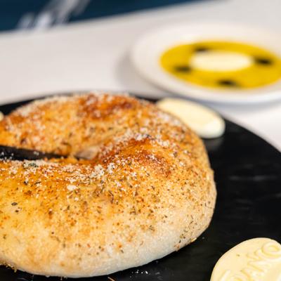 Focaccia Bread accompanied by small butter portions, close-up.