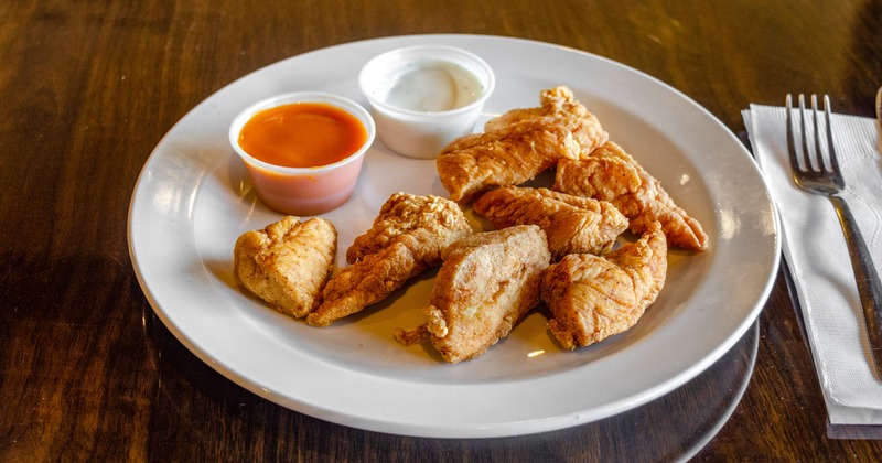 Fried boneless chicken wings with dressings