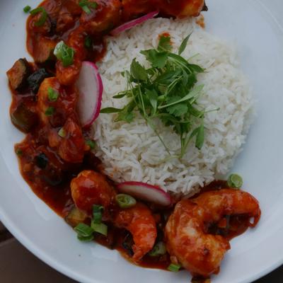 Spicy shrimp with rice, scallions, cilantro, and radish.