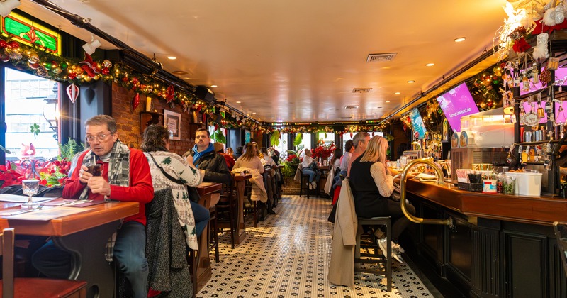 Wide view to restaurant, diner and bar area, tables and chairs, guests