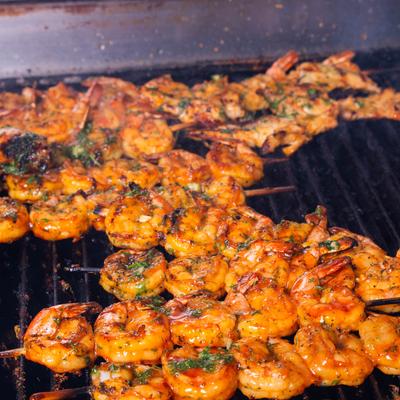 Shrimp skewers cooking on the grill.