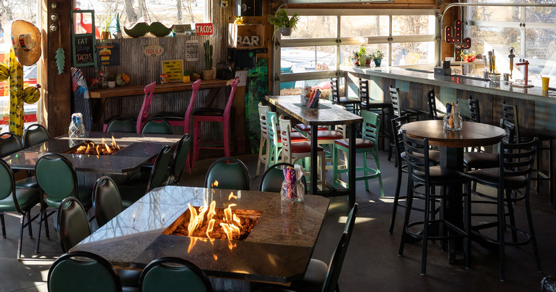 Interior, tables with small pit fires in the middle