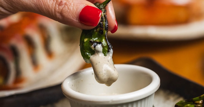 A hand holding dipped food