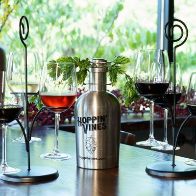 Assorted glasses of wine and a metal bottle.