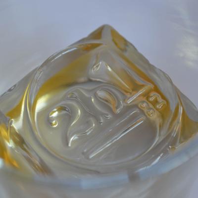 A crystal-clear ice cube with '2b1' engraved on it.