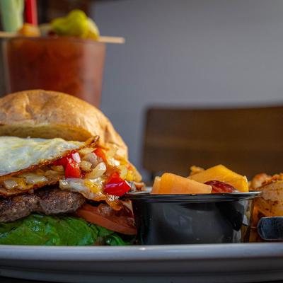 Denver style burger served with potatoes and fresh fruit cup.