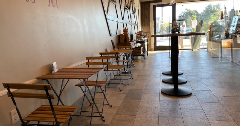 Interior space, seating area, tables for two lined up by the wall