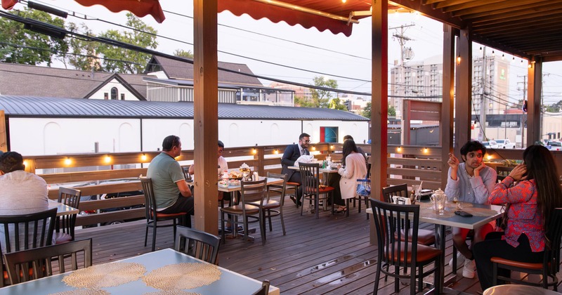 Exterior, patio, guests sitting at the tables and chatting