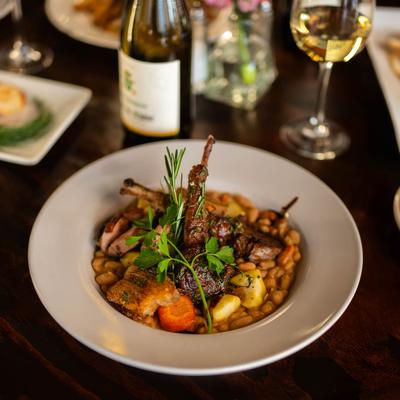 Cassoulet of Lamb, Duck & Pork served with wine.