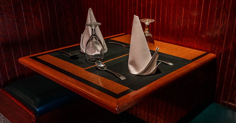 Dining table, with utensils, glasses, and napkins