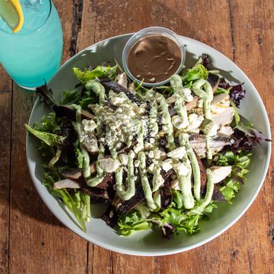 Salad with mixed greens, cold grilled chicken, mushrooms, blue cheese, basil pesto, and balsamic.