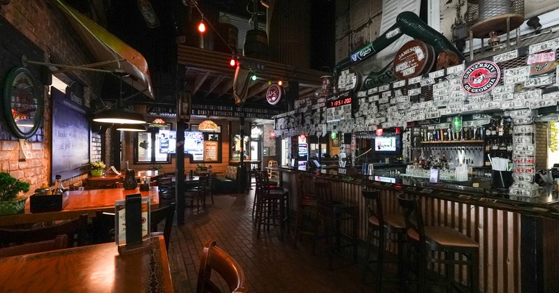 Interior, tables and chairs on the left, bar and bar stools on the right