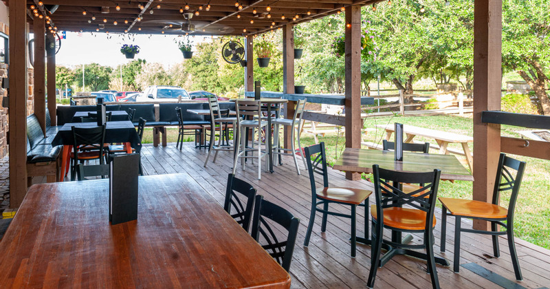 Exterior, covered patio area with guest tables and seats